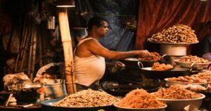 Surat is often celebrated for its diamonds, textiles, and fast-growing urban culture, but the city’s food scene deserves equal attention. From buttery pav bhaji and spicy misal pav to crispy khaman, locho, and late-night street snacks, the street food in Surat reflects the city’s vibrant personality and love for bold flavours. Whether you are a tourist exploring Gujarat or a local foodie searching for hidden gems, Surat offers an unforgettable culinary experience that combines Gujarati comfort food with Maharashtrian spice, North Indian indulgence, and unique local creations. In this guide, we explore the best street food in Surat, famous food streets, must-try dishes, and where to find the most loved snacks across the city. Why Street Food In Surat Is So Popular Surat has evolved into one of Gujarat’s most exciting food destinations. The city is known for its energetic food culture, where locals enjoy everything from quick evening snacks to elaborate midnight food trails. One of the biggest reasons behind the popularity of street food in Surat is variety. You can find traditional Gujarati snacks alongside spicy Mumbai-style favourites, fusion dishes, and rich North Indian street food at affordable prices. Another reason is the city’s love for food gatherings. Popular food streets remain crowded late into the night, especially during weekends and festive seasons. Famous Street Food Areas In Surat Gopi Talav Food Zone Gopi Talav has become one of the city’s most popular food destinations. From local snacks to trendy fusion dishes, the area attracts huge crowds every evening. You can try: Pav bhaji Dabeli Chinese bhel Kulfi Sandwiches Chaat varieties The lively atmosphere makes it one of the best places to experience street food in Surat. Khaudra Gali Khaudra Gali is a paradise for food lovers. This street is famous for affordable snacks and traditional Surti flavours. Popular items include: Locho Sev khamani Surti ghari Vada pav Chole bhature Misal pav If you want authentic local food, this is a must-visit spot. Vesu Food Street Vesu is known for modern cafés and trendy food stalls. Young crowds often visit this area for fusion street food and late-night snacks. Top dishes include: Cheese-loaded pav bhaji Momos Mexican sandwiches Chocolate desserts Loaded fries Must-Try Street Food In Surat Locho Locho is Surat’s signature dish and one of the most iconic snacks in Gujarat. Made from steamed gram flour batter and topped with butter, spices, chutneys, and sev, this soft savoury dish is unique to Surat. No street food trail in Surat is complete without trying locho. Sev Khamani Sev khamani is another beloved Surti snack made with crumbled chana dal and topped with sev, pomegranate, onions, and spices. It offers the perfect balance of sweet, spicy, and tangy flavours. Best Chaat In Surat If you are searching for the best chaat in Surat, you will find endless options across the city. From pani puri and dahi puri to ragda patties and bhel puri, Surat’s chaat scene is incredibly diverse. Popular places serve: Crispy pani puri Loaded sev puri Dahi papdi chaat Ragda chaat Aloo tikki The combination of spicy chutneys, crunchy textures, and fresh toppings makes Surat one of Gujarat’s top destinations for chaat lovers. Best Pav Bhaji In Surat The best pav bhaji in Surat is known for its rich buttery flavour and spicy vegetable mash served with toasted pav. Many food stalls prepare pav bhaji using extra butter, fresh coriander, and special masala blends that attract huge crowds every evening. Some places even offer: Cheese pav bhaji Jain pav bhaji Tawa pulao combos Extra spicy versions Best Vada Pav In Surat The best vada pav in Surat combines spicy potato filling, crispy batter coating, soft pav, and flavourful chutneys. This Mumbai favourite has become extremely popular in Surat, especially among students and office-goers looking for quick and affordable snacks. Cheese vada pav and schezwan vada pav are trending choices among younger food lovers. Best Misal Pav In Surat Misal pav has gained massive popularity in Surat over the past few years. The best misal pav in Surat features spicy curry topped with farsan, onions, coriander, and buttery pav. Food lovers often prefer: Kolhapuri-style misal Cheese misal pav Extra spicy misal Butter-loaded pav options The bold flavours make it one of the city’s fastest-growing street food favourites. Best Chole Bhature In Surat The best chole bhature in Surat is loved for its fluffy bhature and spicy Punjabi-style chole. Many eateries serve this dish as a filling breakfast or evening meal. You can also find: Paneer chole bhature Amritsari chole Extra butter bhature Masala onion toppings This North Indian favourite has become a major part of Surat’s street food culture. Sweet Treats You Should Not Miss Surti Ghari Surti ghari is one of the city’s most famous traditional sweets. Made with mawa, dry fruits, and ghee, this rich dessert is especially popular during festivals. Kulfi And Falooda Many late-night food stalls in Surat serve creamy kulfi and falooda loaded with nuts, rose syrup, and ice cream. These desserts are perfect after a spicy street food binge. Tips For Exploring Street Food In Surat Visit food streets during evening hours for the best variety. Weekends are usually crowded, especially after 8 PM. Carry cash as smaller vendors may not accept digital payments. Try local Surti dishes instead of sticking only to common snacks. Explore different areas because every food zone has its own speciality. Best Time To Enjoy Street Food In Surat The ideal time to explore street food in Surat is between October and February when the weather is pleasant. Evening food walks become much more enjoyable during winter months. Monsoon season is also popular for hot snacks like bhajiya, locho, and chai. A Delicious Journey Through Surat’s Food Streets Street food in Surat is more than just quick bites — it is an experience filled with flavour, culture, and local energy. From iconic Surti snacks like locho and sev khamani to spicy misal pav, buttery pav bhaji, and delicious chaat, the city offers something for every food lover. Whether you are hunting for the best chaat in Surat, craving the best vada pav in Surat, or planning a late-night food trail with friends, Surat’s vibrant food streets promise unforgettable memories and incredible flavours. If you truly want to understand the spirit of Surat, start with its street food