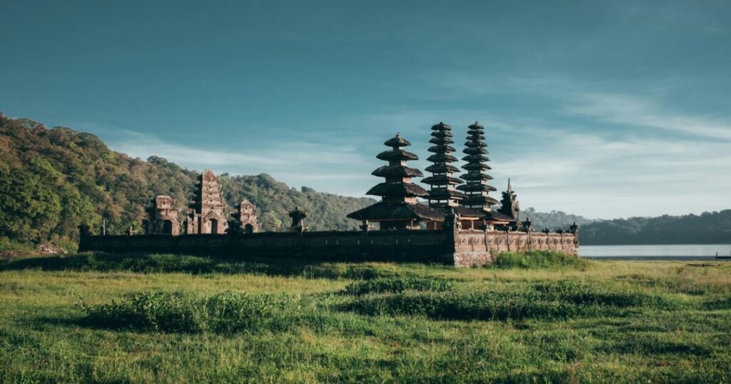 Bali vs Thailand travel essentials flat-lay including passport, international driving permit, USD cash and adventure gear