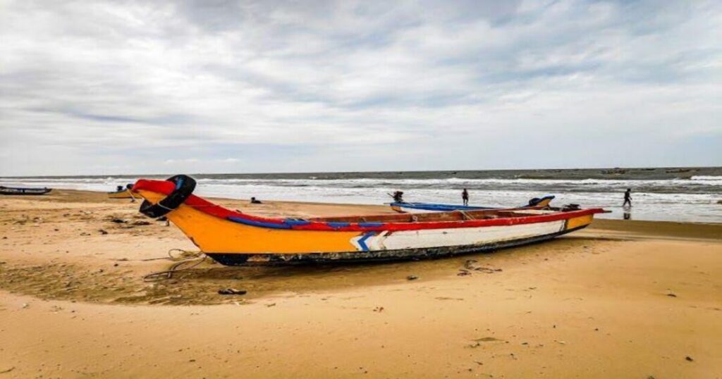 Colourful fishing boats returning to shore at Vodarevu Beach near Chirala
